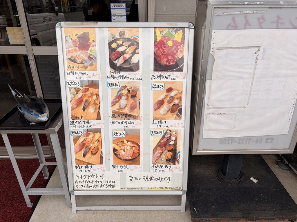 大和寿司の店頭メニューボード。写真つきで9品が並ぶ